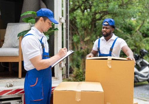 imgi_14_man-mover-blue-uniform-checking-lists-clipboard-while-unloading-cardboard-boxes-from-truck_34755-1587